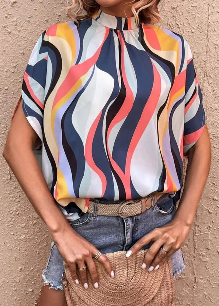 Orange printed dolman sleeve top with black accents