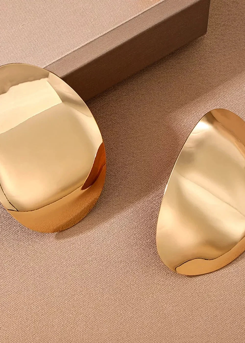 Gold plated alloy curved statement earrings