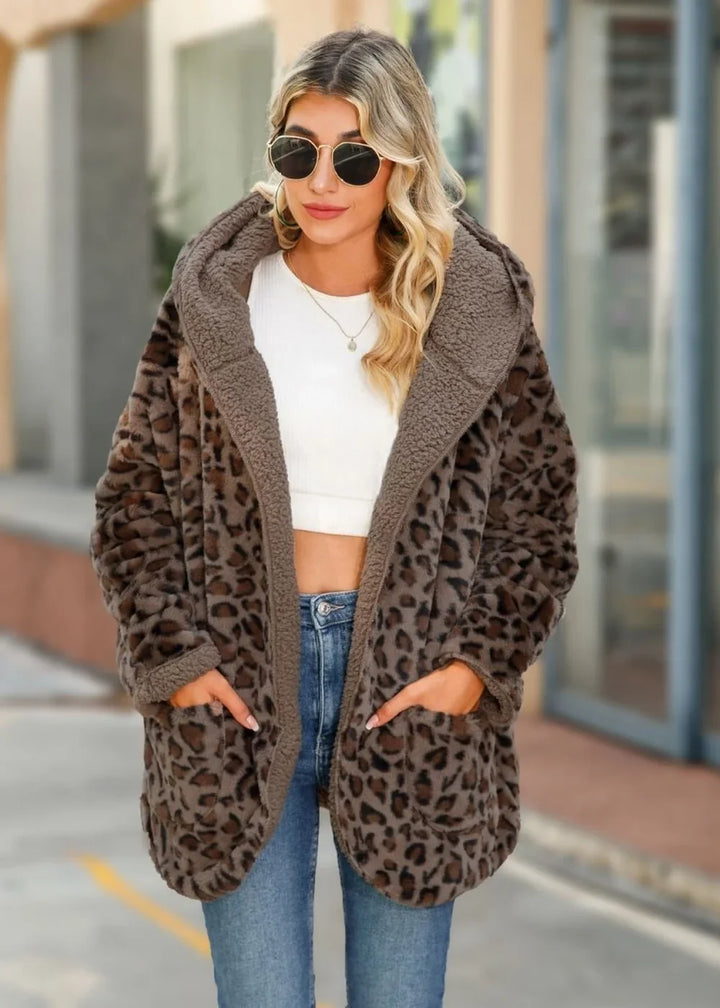 Cozy leopard print fuzzy jacket with plush lining and pockets on model.