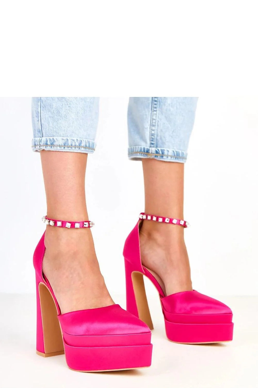 Hot pink satin platform heels with jeweled ankle straps, worn with cuffed jeans.