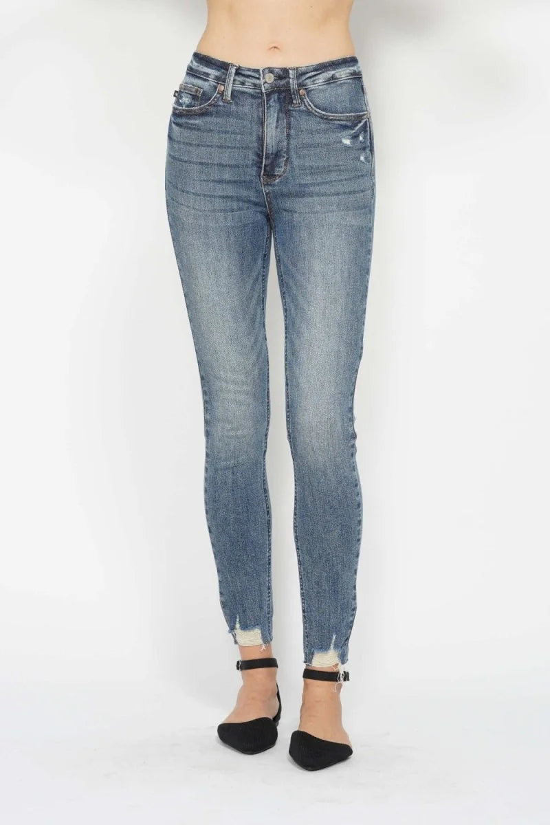 Medium wash Judy Blue skinny jeans with distressed hem.
