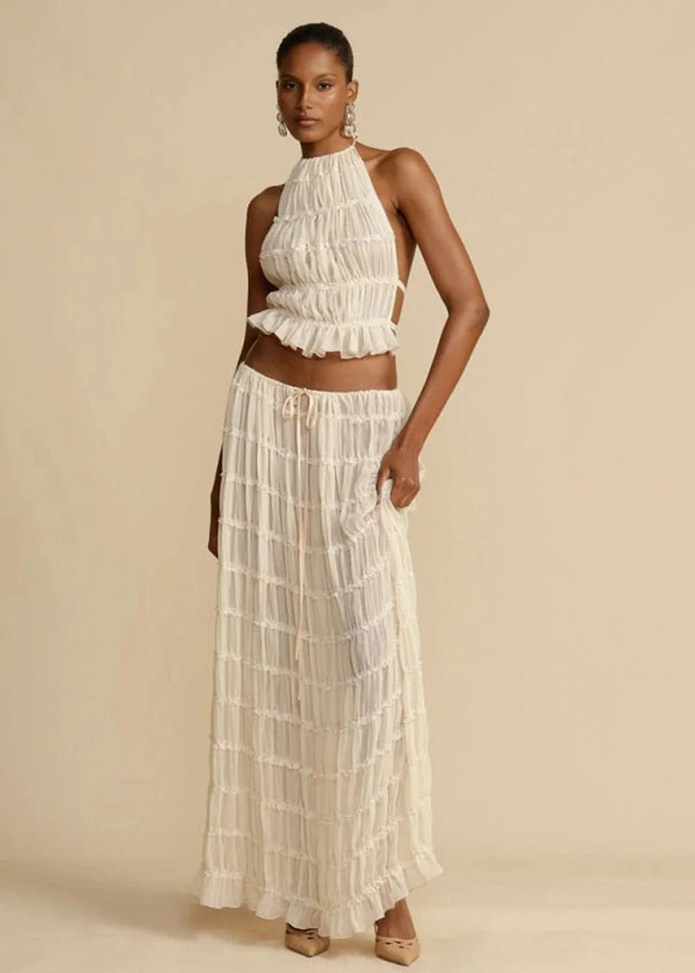 Cream ruched halter top and matching maxi skirt with tie waist, on model.