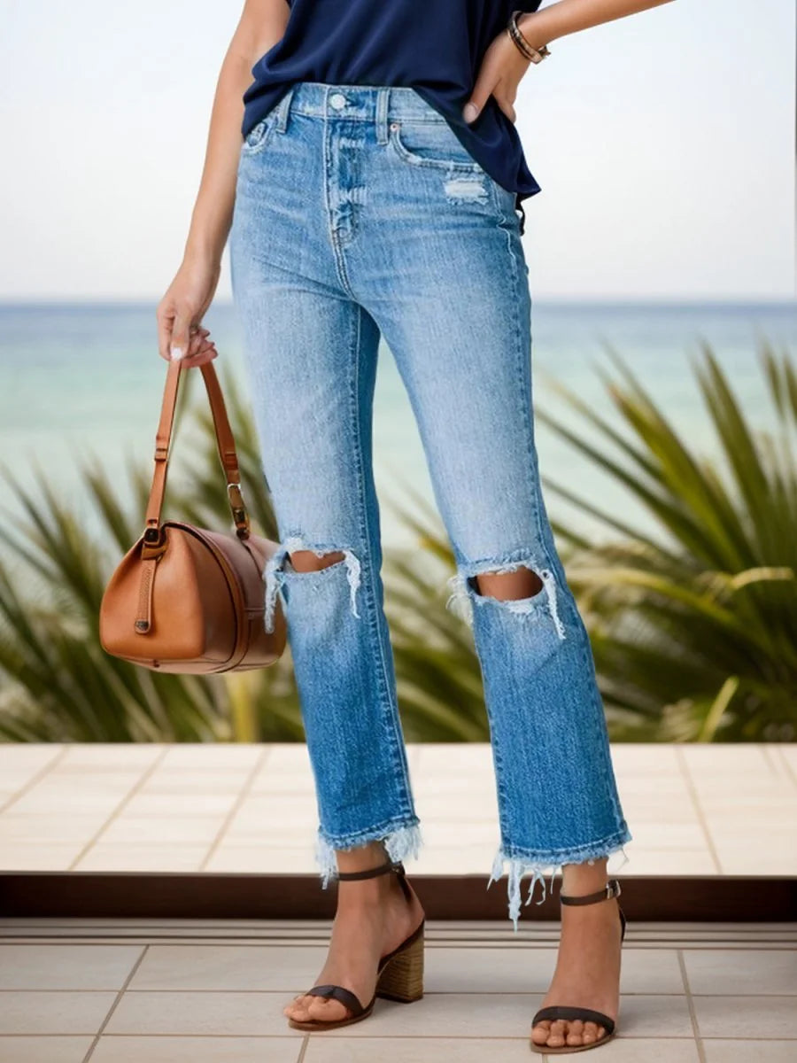 Light wash distressed raw hem jeans with pockets