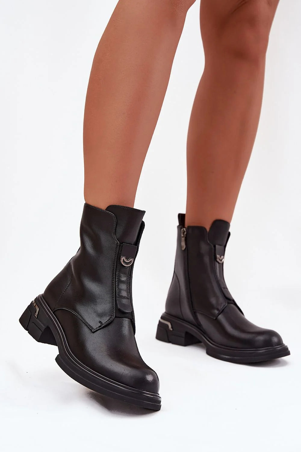 Black leather ankle boots with a zipper and buckle detail on a white background.