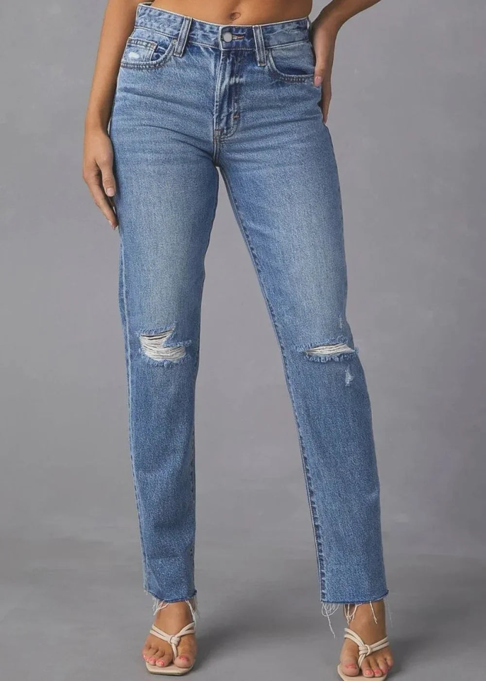 Women's medium wash distressed raw hem straight jeans