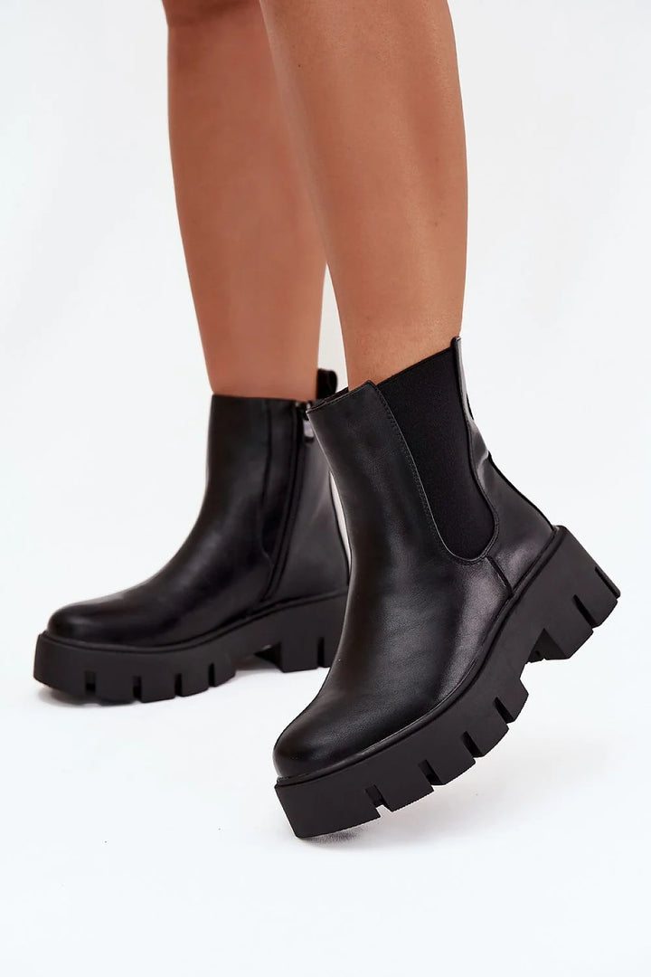 Black faux leather platform Chelsea boots with elastic side panels and zipper closure.