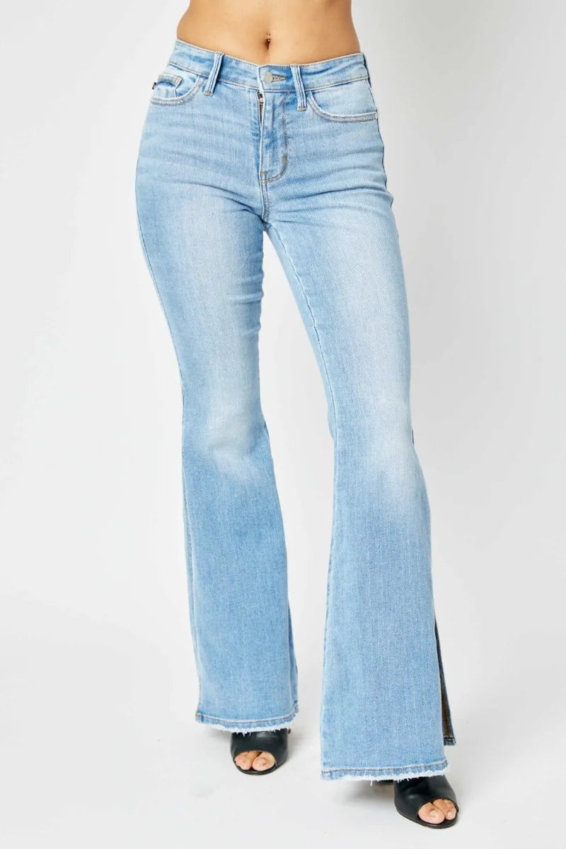 Medium wash mid-rise flare jeans with raw hem
