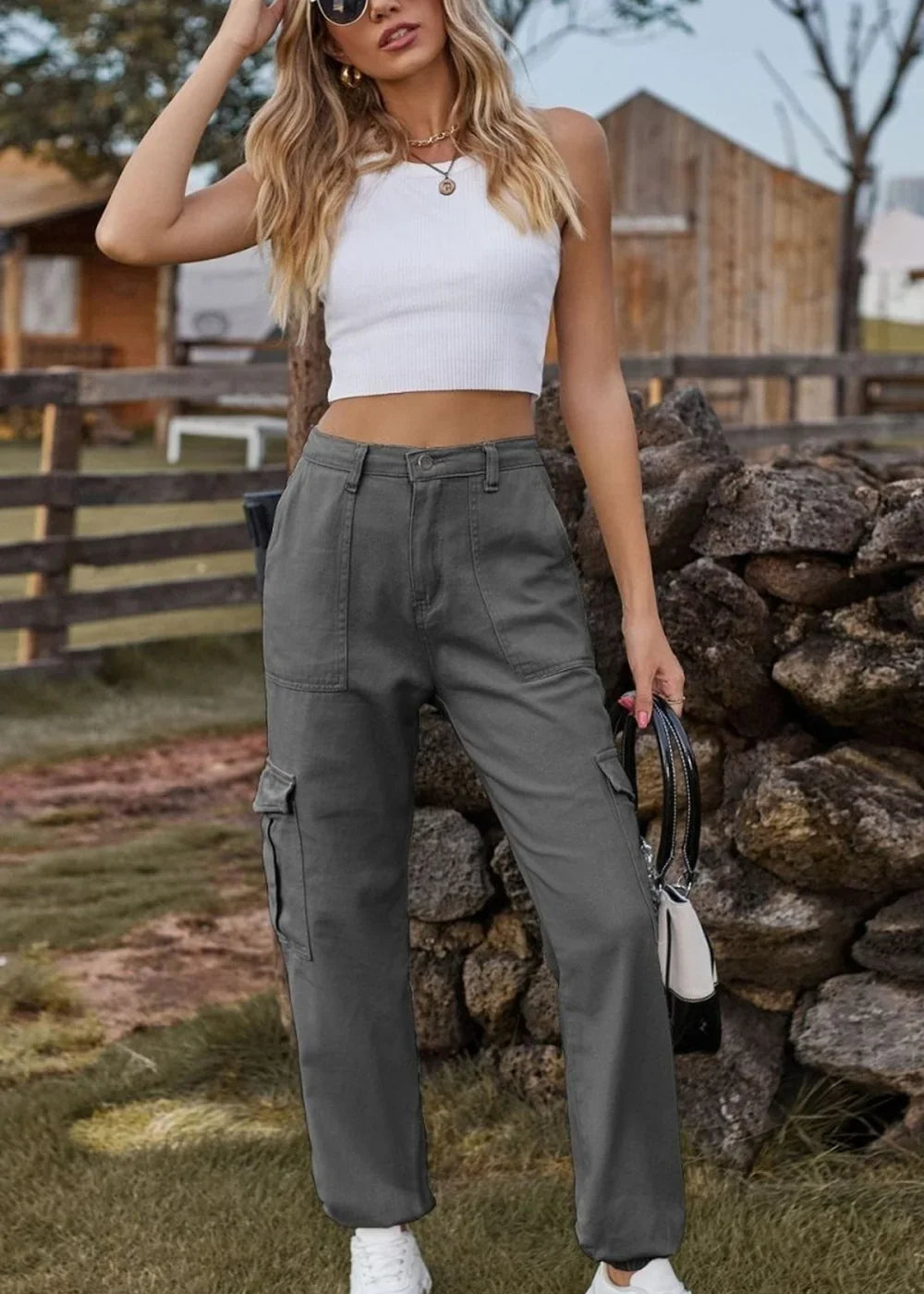 Gray cargo pants with a regular fit and utility pockets, shown on a model.
