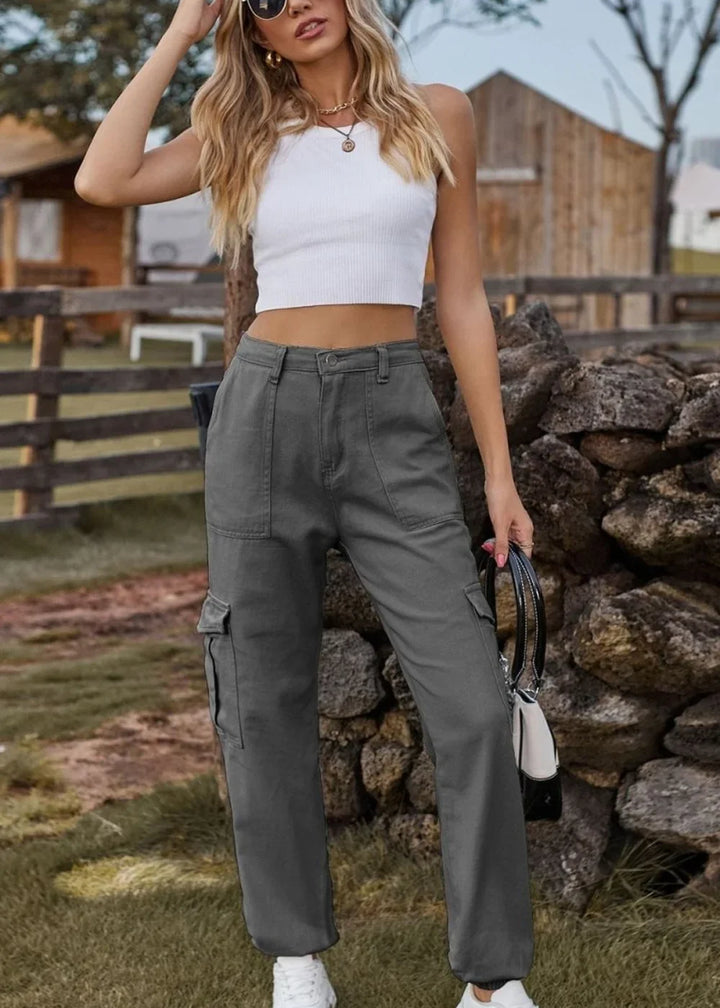 Gray cargo pants with a regular fit and utility pockets, shown on a model.
