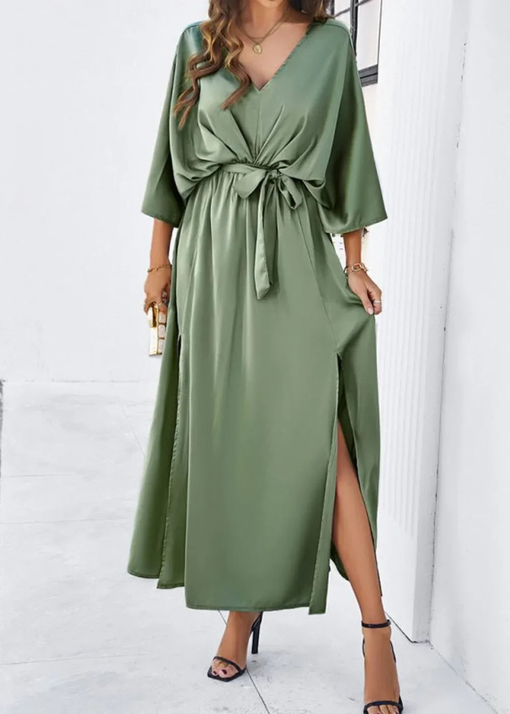 Flowy sage green satin maxi dress with V-neck, self-tie waist, and thigh-high slits, on model.