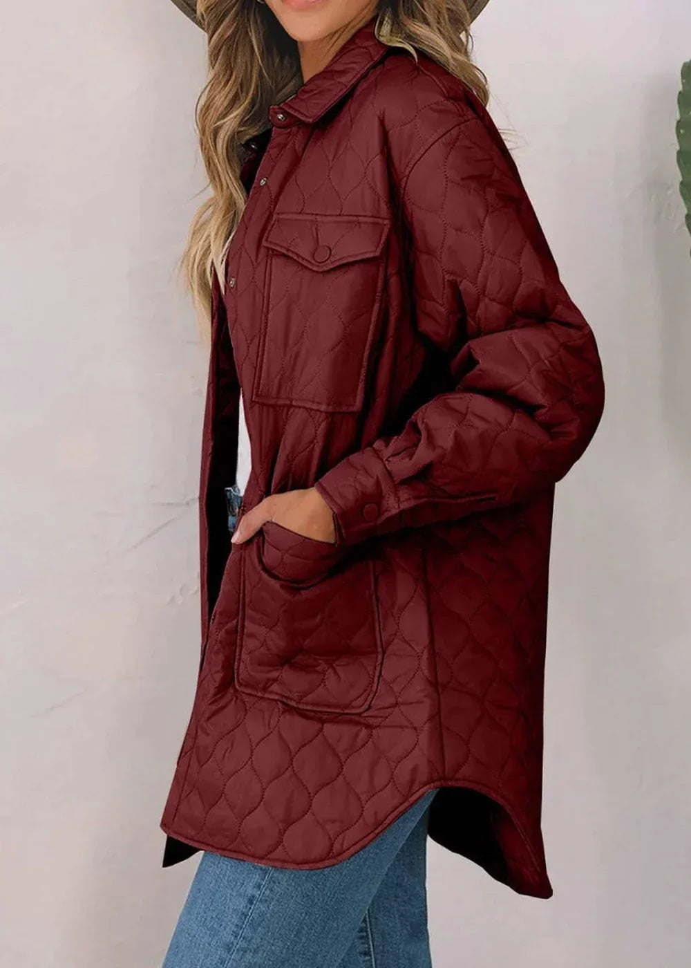 Quilted burgundy nylon jacket with button-flap chest pockets and a relaxed fit on a model.