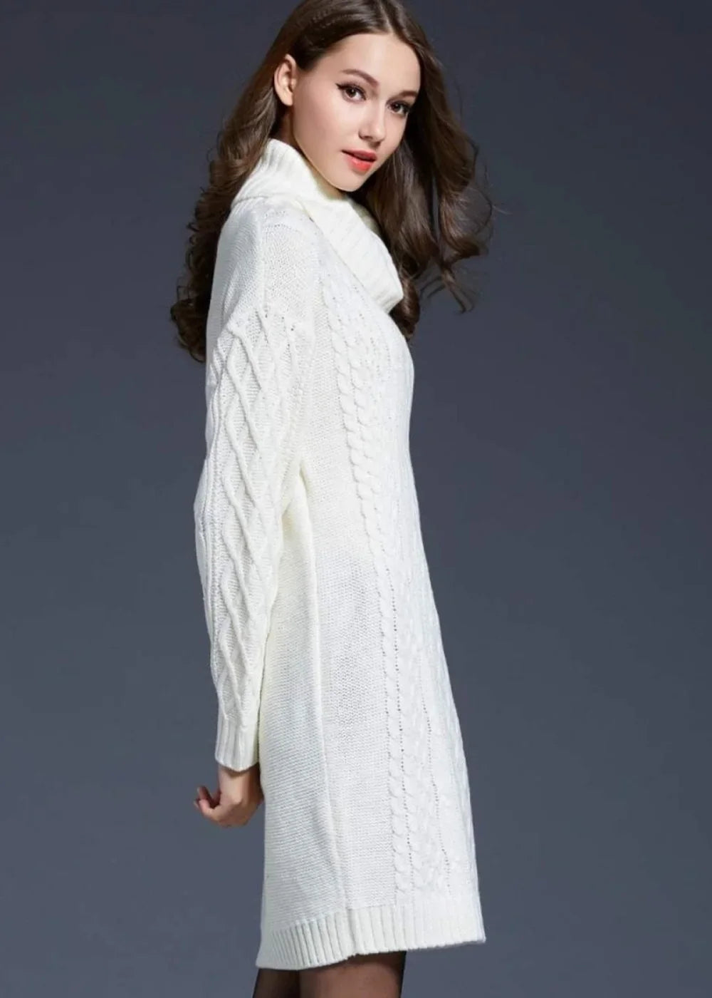 White cable knit sweater dress with a cowl neck, on a model.