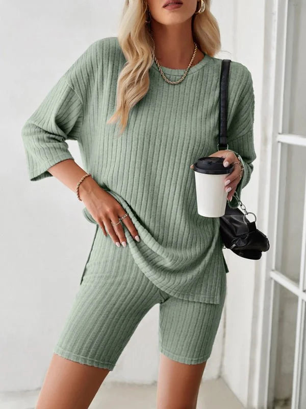 Sage green ribbed knit short suit with relaxed fit top and biker shorts, on model.