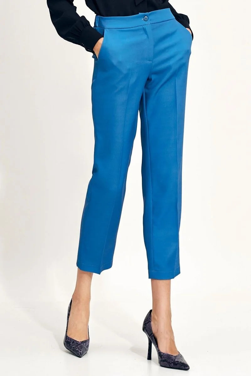 Blue straight-leg cropped pants with a regular fit, shown on a model with patterned heels.