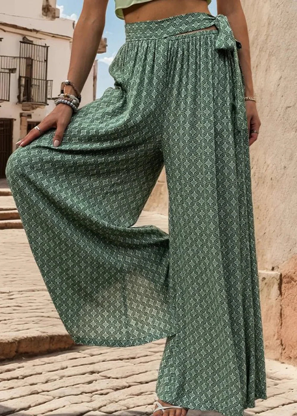 Green wide-leg pants with a diamond pattern and a tie waist.