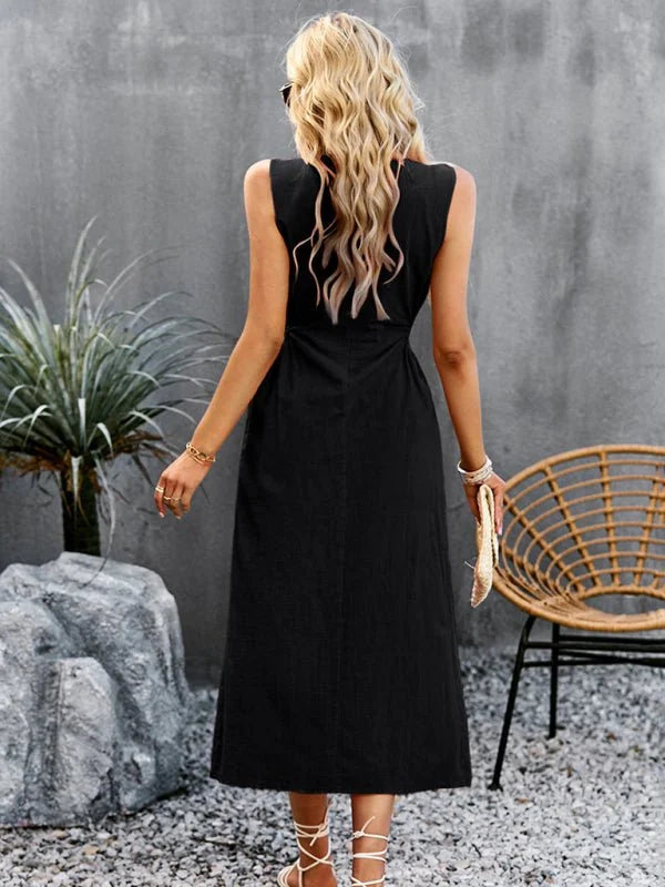 Black sleeveless midi dress with a textured fabric, shown from the back on a model.
