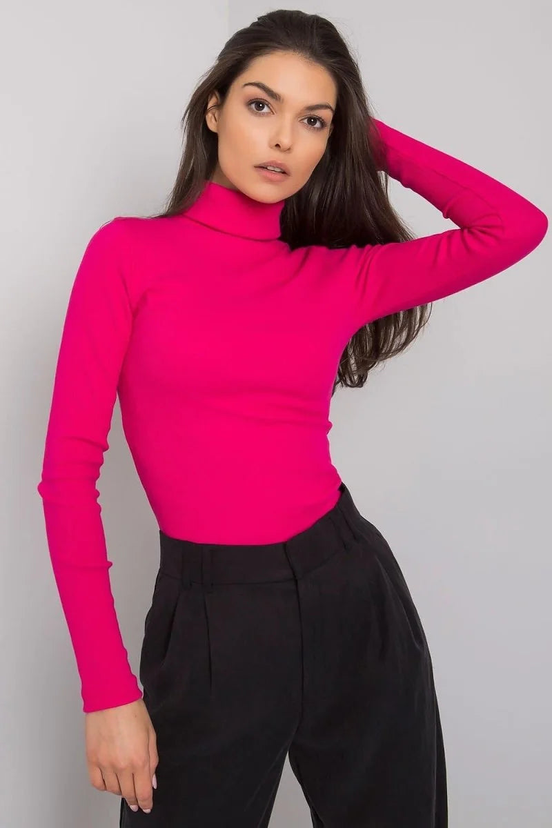 Fitted hot pink turtleneck long-sleeve top on a model wearing black pants.