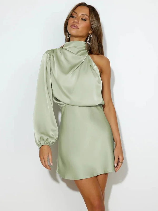 Sage green satin one-shoulder dress with a draped neckline and long balloon sleeve on a model.