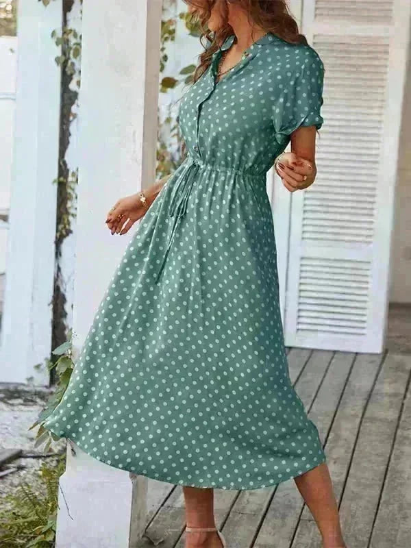 Green polka dot rayon midi dress with drawstring waist and short sleeves, on model