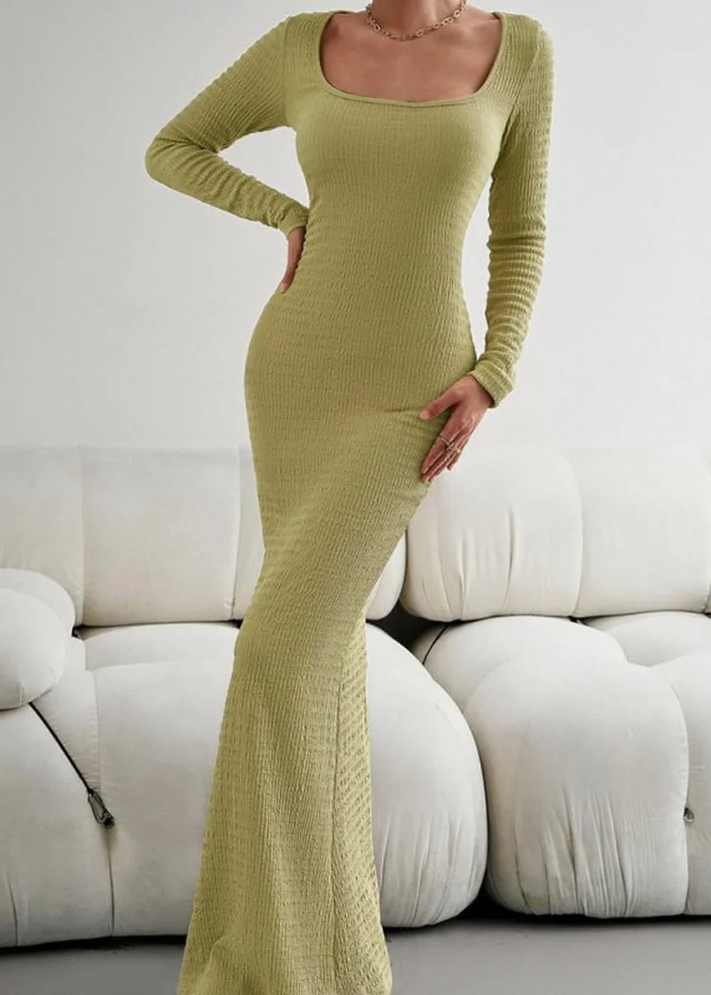 Olive green ribbed maxi dress with long sleeves and a square neckline, fitted on a model.