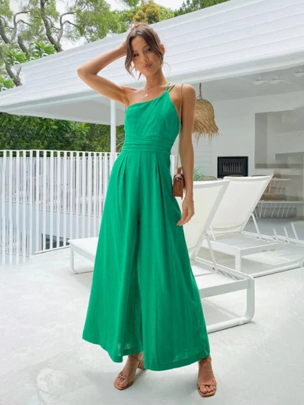 Green one-shoulder wide-leg jumpsuit with cinched waist and textured fabric.