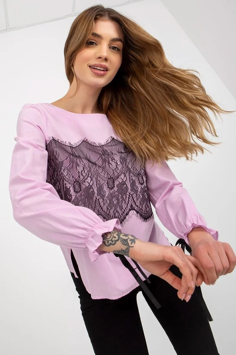 Light pink long-sleeve top with black lace overlay on the chest and ruffled cuffs with ties.