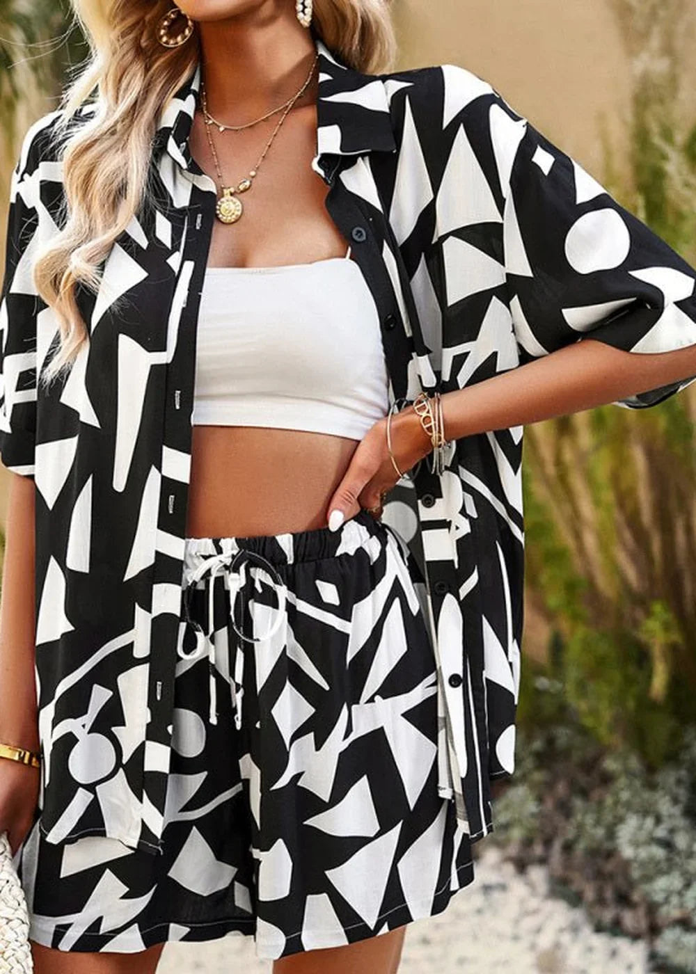 Black and white abstract print viscose shirt and shorts set on model.