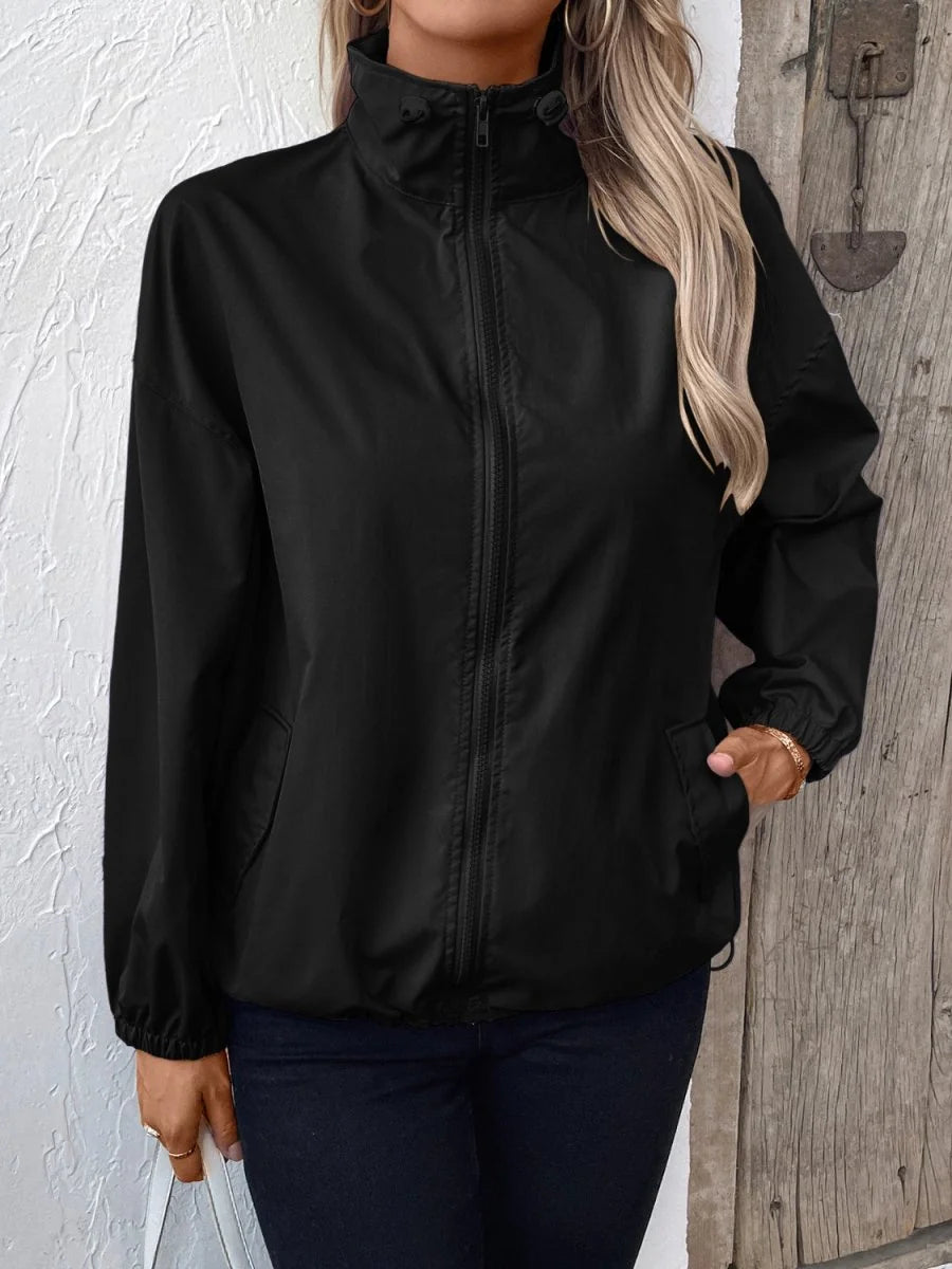Black polyester jacket with a stand-up collar and zip-front closure, on a model.