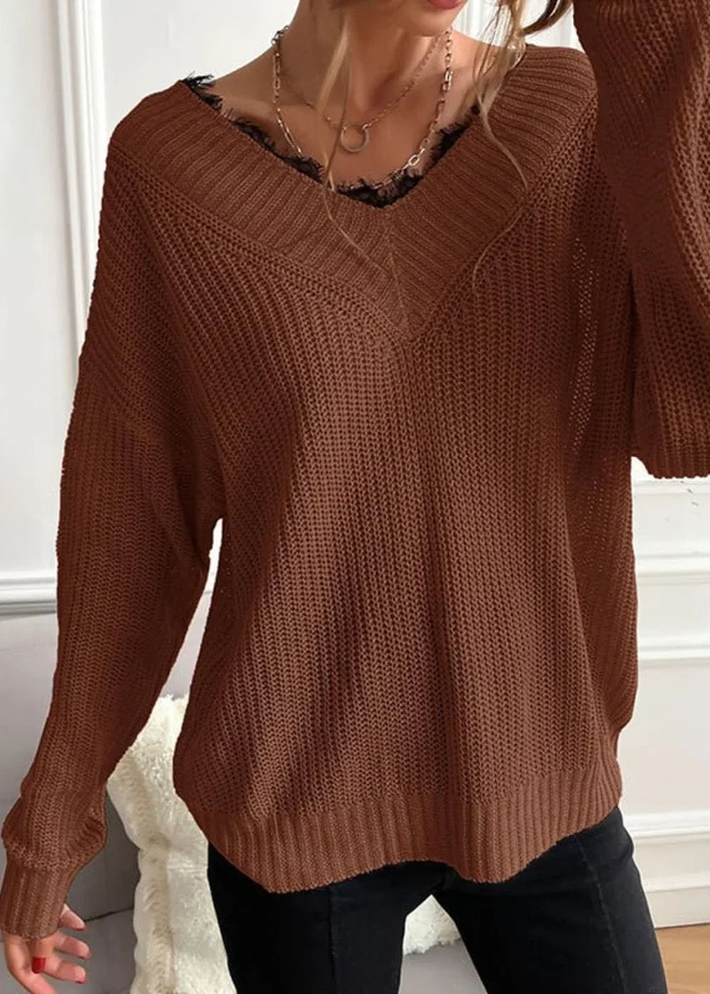 Brown knit sweater with lace trim at V-neck, on model.