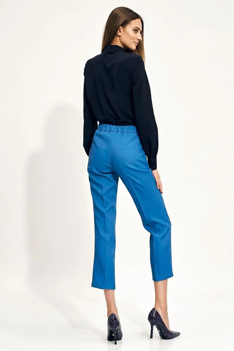Bright blue cropped pants with a regular fit, elastic waistband, and subtle seam details, shown on a model.