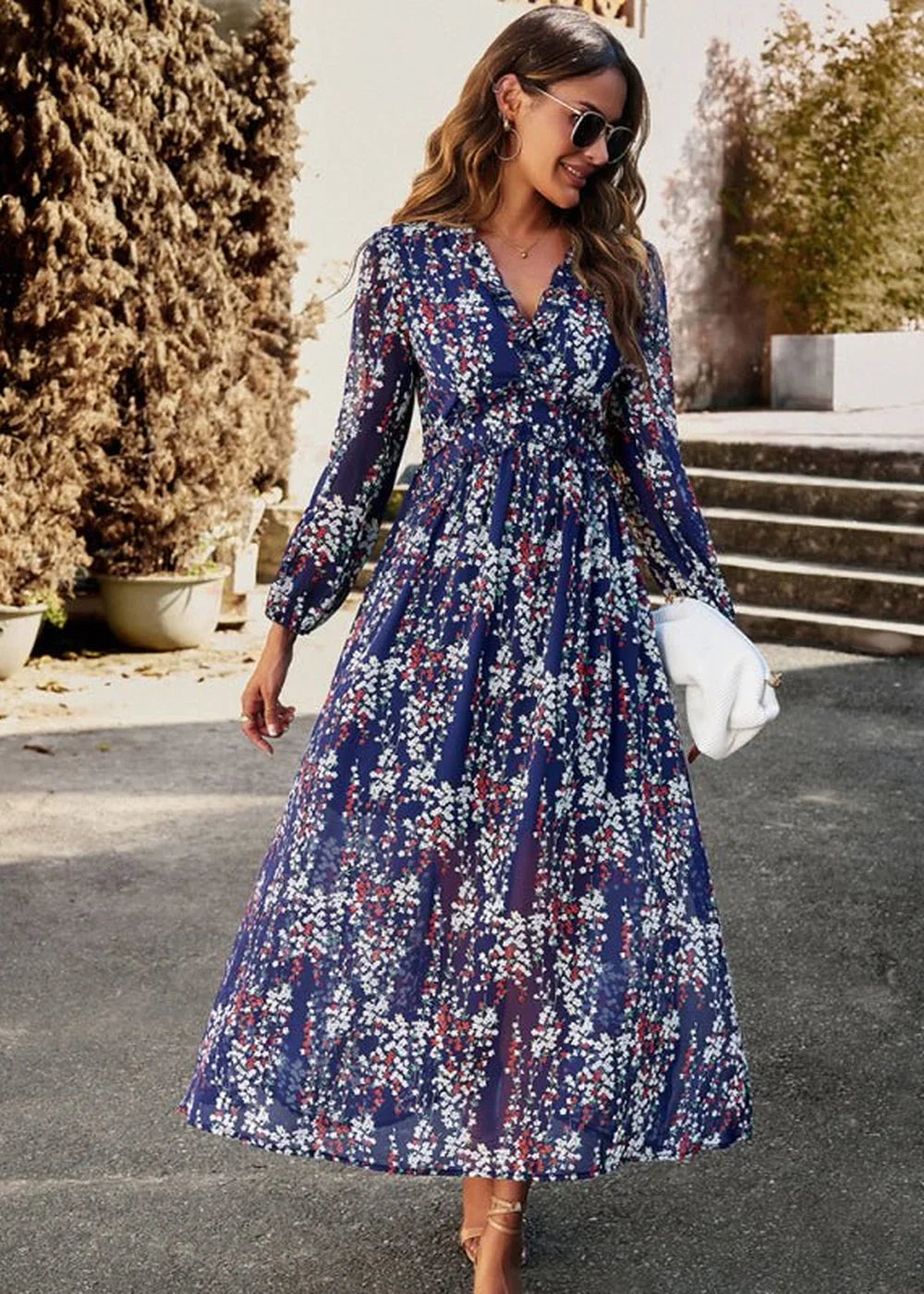 Navy blue floral maxi dress with long sleeves and a V-neck, worn by a model.
