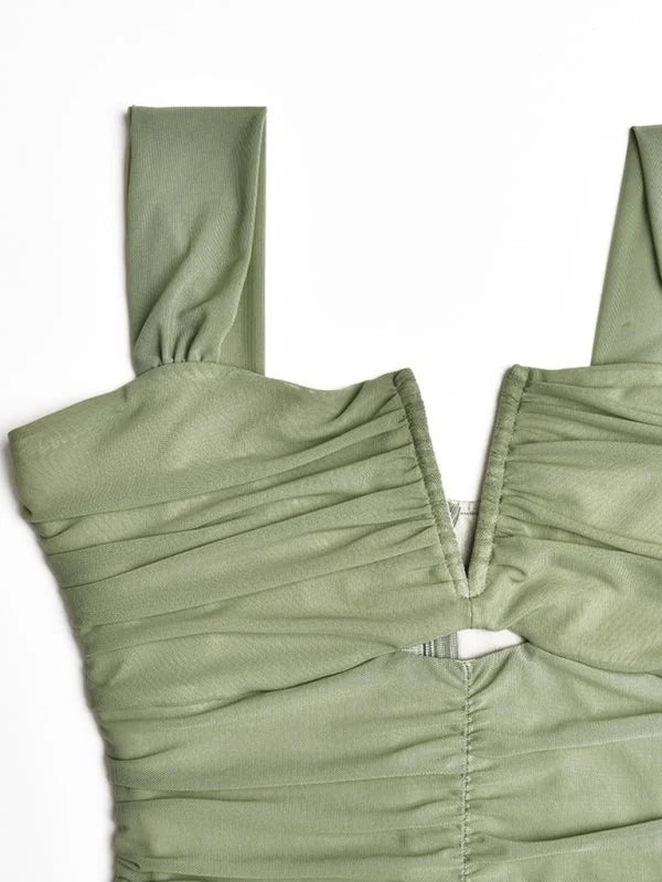 Sage green ruched mesh dress with a plunging neckline and cutout detail, close-up.