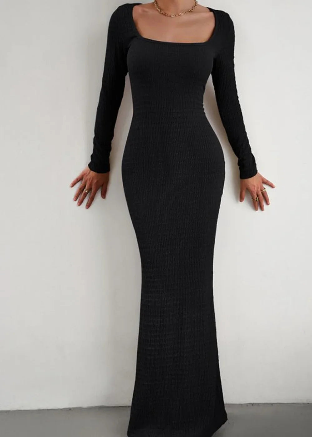 Black ribbed long-sleeve maxi dress with a square neckline, fitted silhouette.