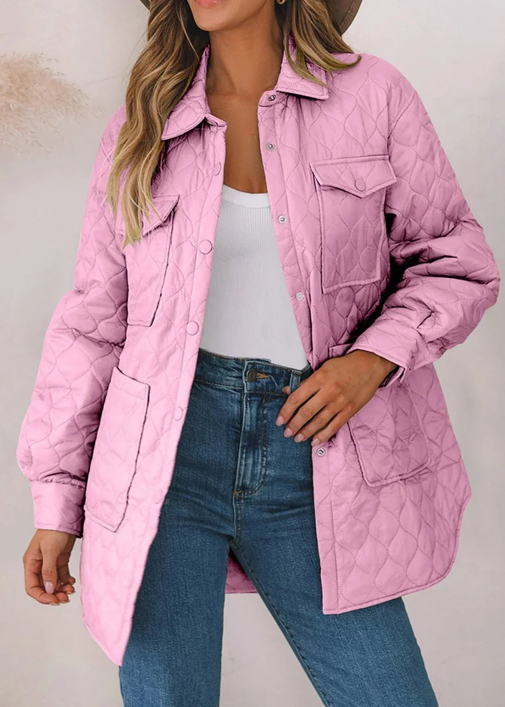 Pink quilted shacket with button-front closure, patch pockets, and denim jeans on model.