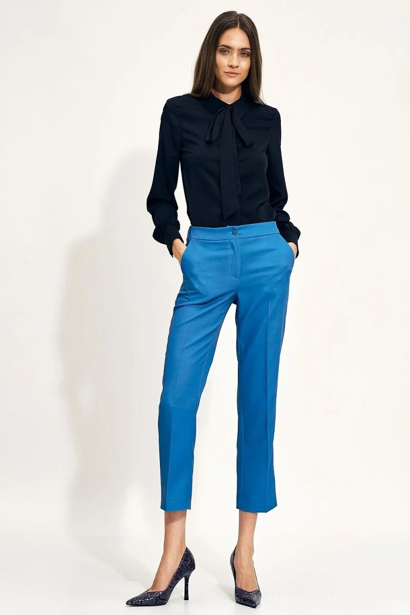 Blue high-waisted trousers with a regular fit and pockets, shown on a model.