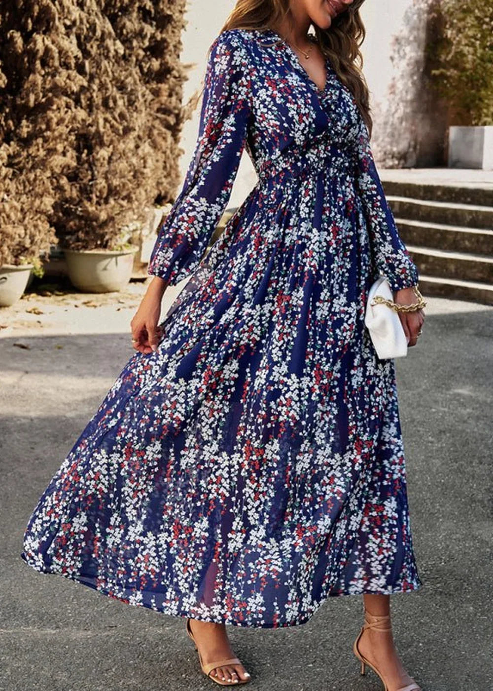 Navy blue maxi dress with a white and red floral pattern, v-neck, and long sleeves.