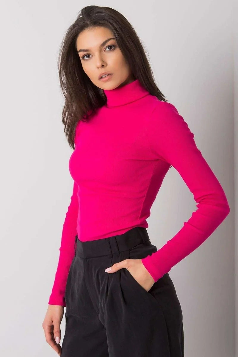 Fitted hot pink ribbed turtleneck top with long sleeves worn by a model with black pants.
