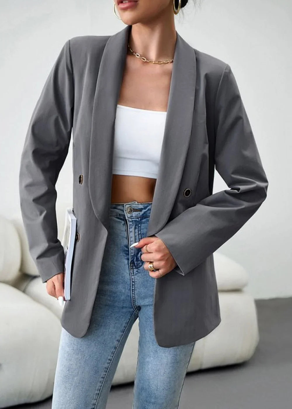 Grey polyester blazer with wide lapels, gold button details, paired with a white crop top and light wash denim jeans.