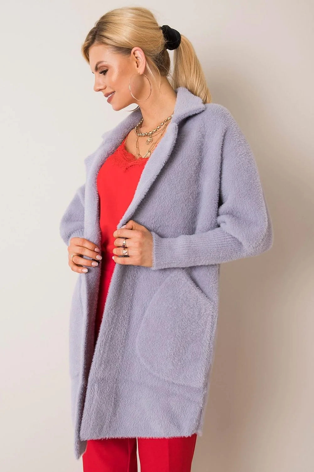 Light purple fuzzy longline cardigan with lapels and pockets on a model.
