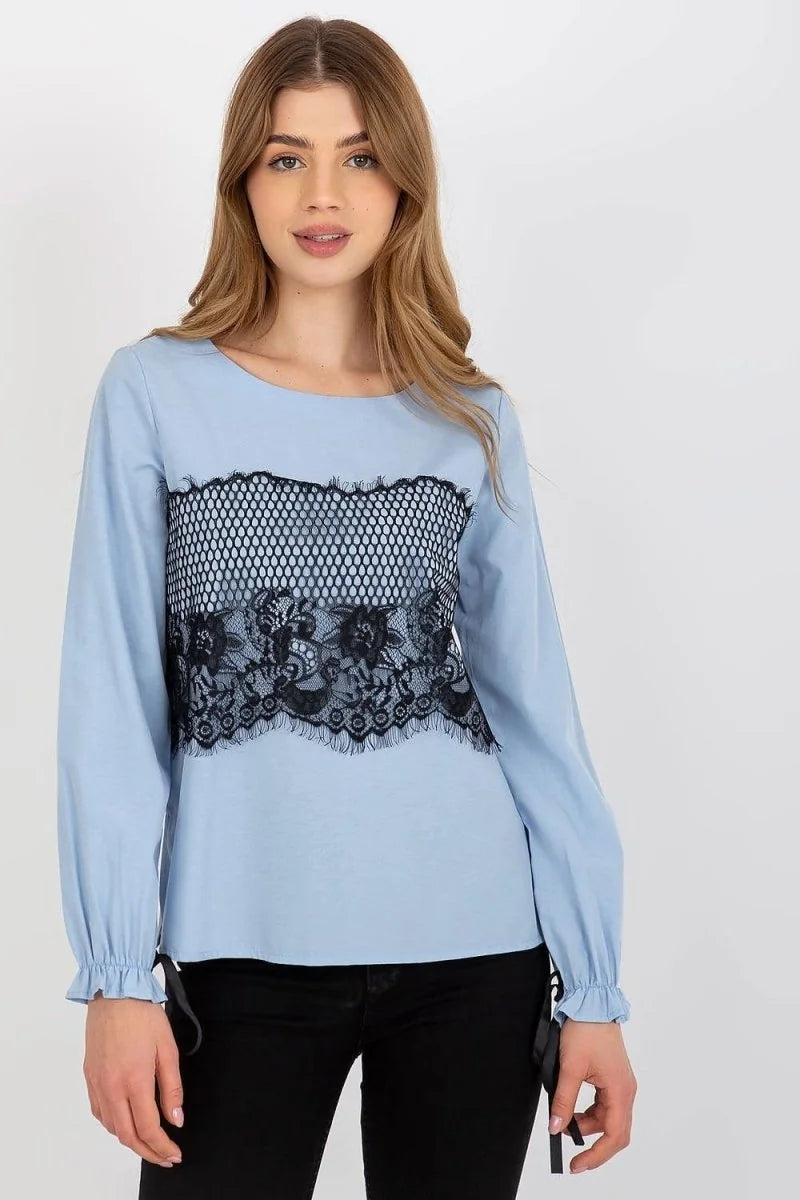 Light blue long-sleeve top with black lace inset across the chest and ruffled cuffs, on a model.
