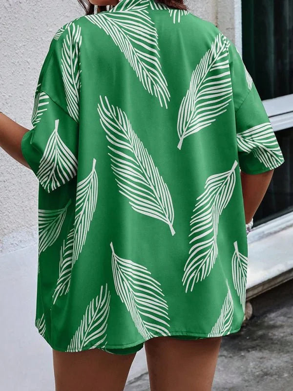 Green short suit with white feather print, showing the back of the top.