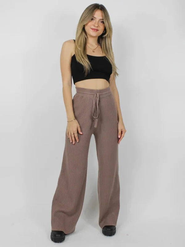 Brown ribbed wide-leg pants with drawstring waist on a model.