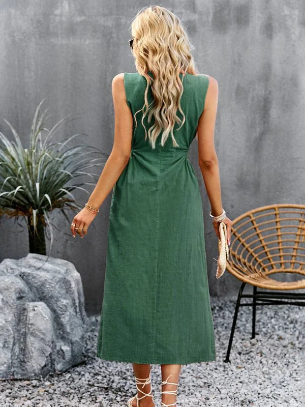 Back view of a sleeveless green dress made of textured polyester-spandex fabric, on a model.