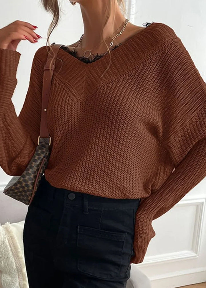 Brown ribbed knit sweater with a V-neck and lace trim, worn with black pants.