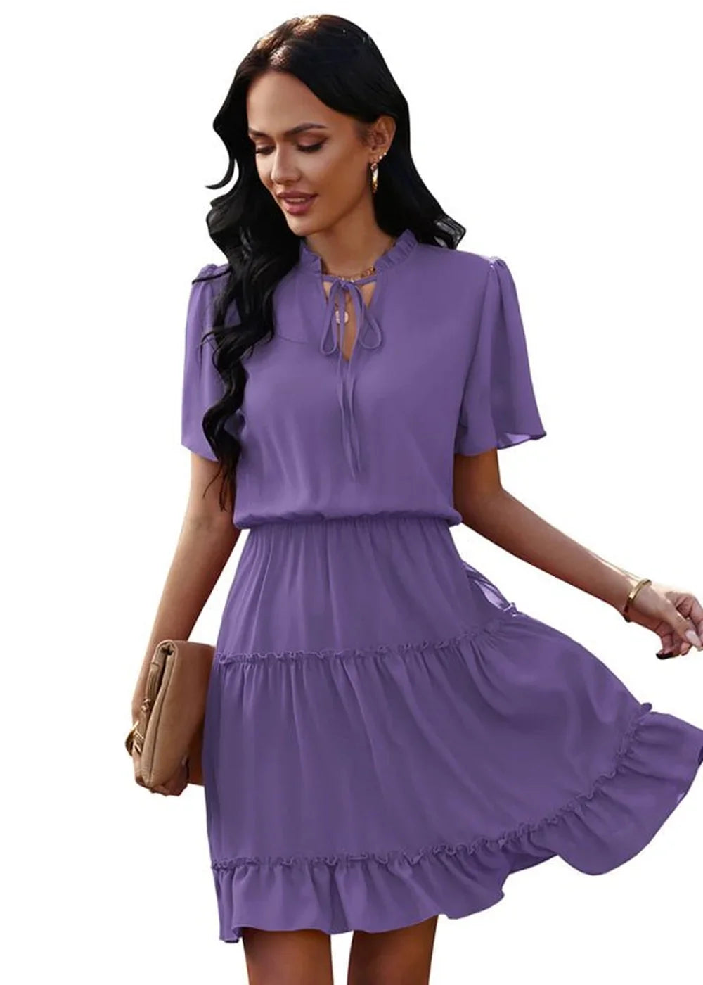 Purple flowy tiered mini dress with flutter sleeves and tie-neck detail, held by a model with a clutch.