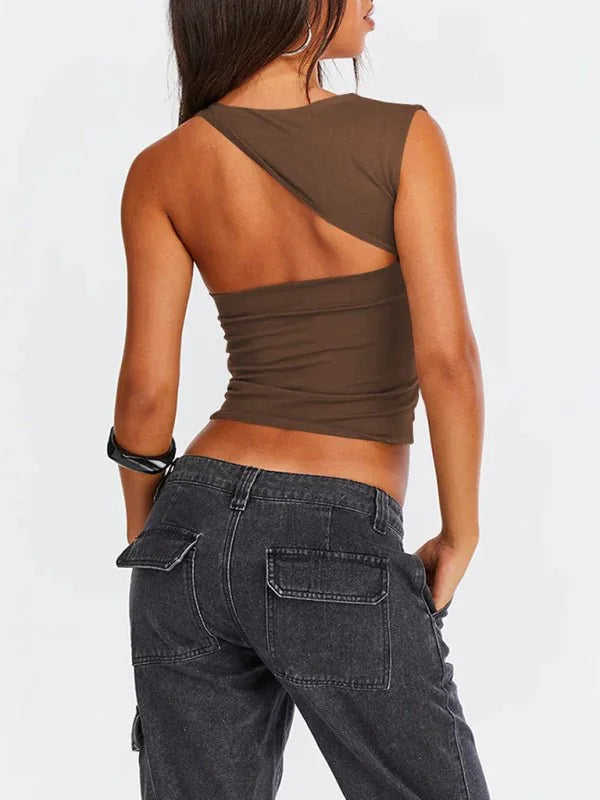 Brown one-shoulder top with cut-out detail, paired with dark wash cargo pants.