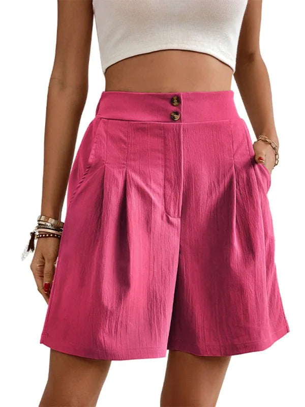 Fuchsia pleated culottes with a textured fabric and double-button waistband, shown on a model.
