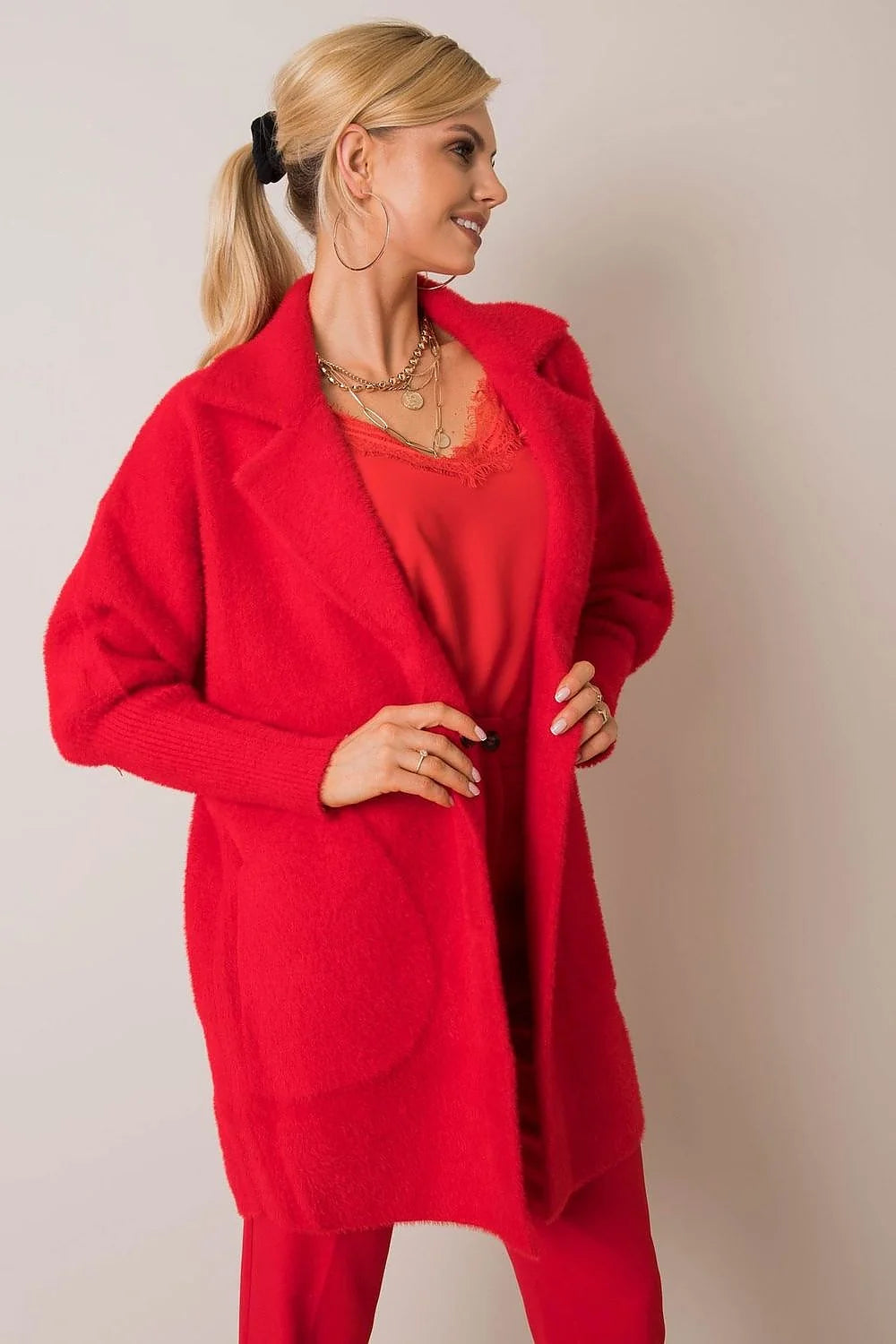 Fuzzy red angora blend cardigan with a relaxed fit, styled with a red lace-trimmed top and gold necklaces.