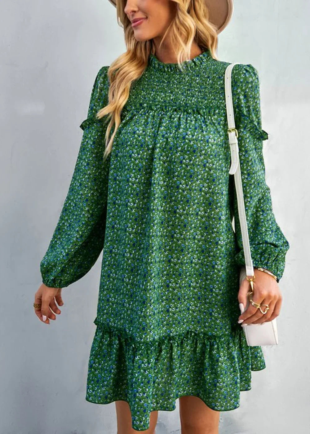 Green floral print dress with smocked neckline and ruffled hem, worn by a model.