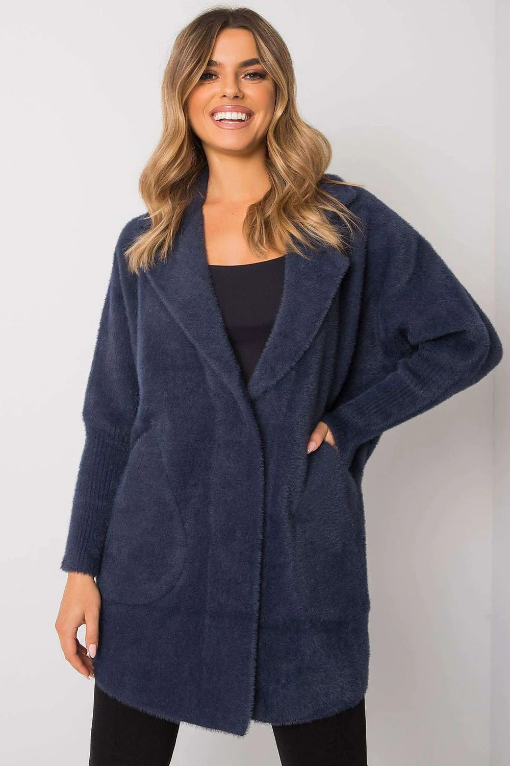 Navy blue fuzzy cardigan with a shawl collar and pockets, shown on a model.